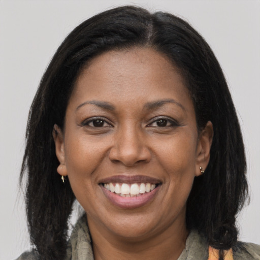 Joyful black adult female with medium  brown hair and brown eyes