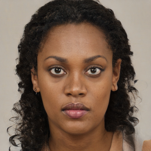 Neutral black young-adult female with long  brown hair and brown eyes