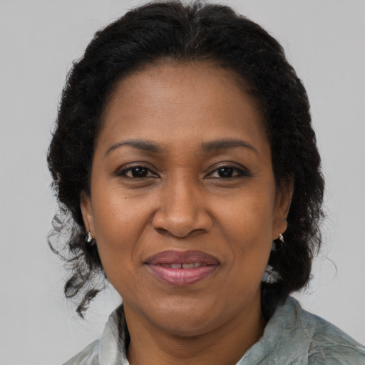 Joyful black adult female with medium  brown hair and brown eyes
