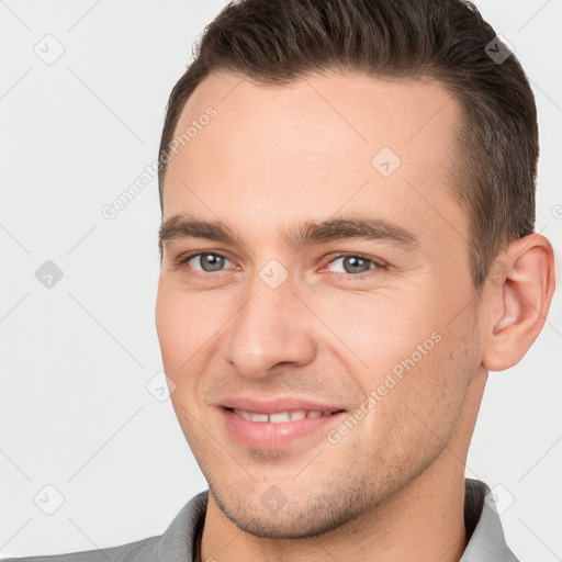 Joyful white young-adult male with short  brown hair and brown eyes