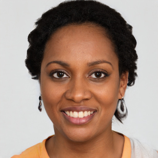 Joyful latino young-adult female with short  black hair and brown eyes