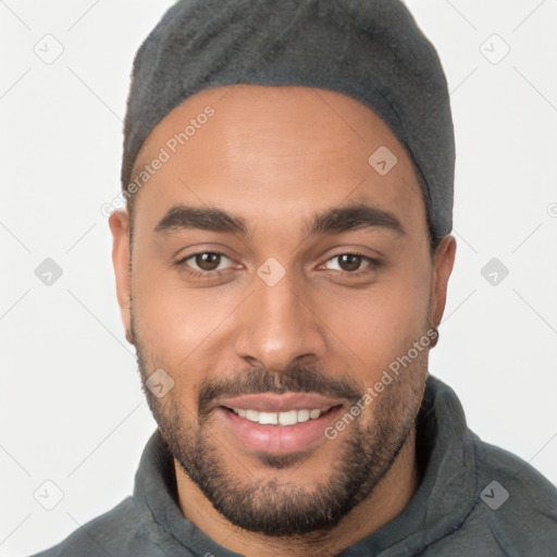 Joyful latino young-adult male with short  brown hair and brown eyes