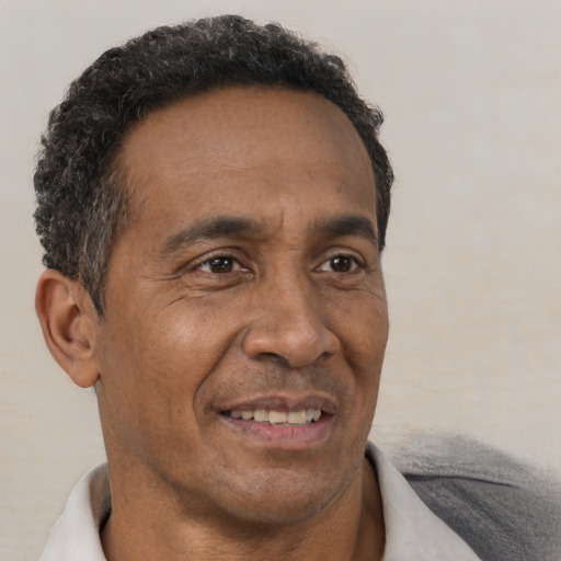 Joyful black adult male with short  brown hair and brown eyes