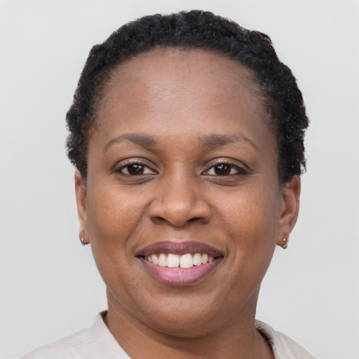 Joyful black adult female with short  brown hair and brown eyes