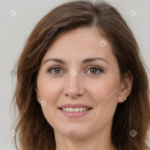 Joyful white adult female with long  brown hair and brown eyes