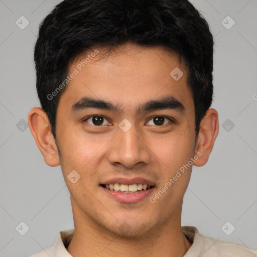 Joyful latino young-adult male with short  brown hair and brown eyes