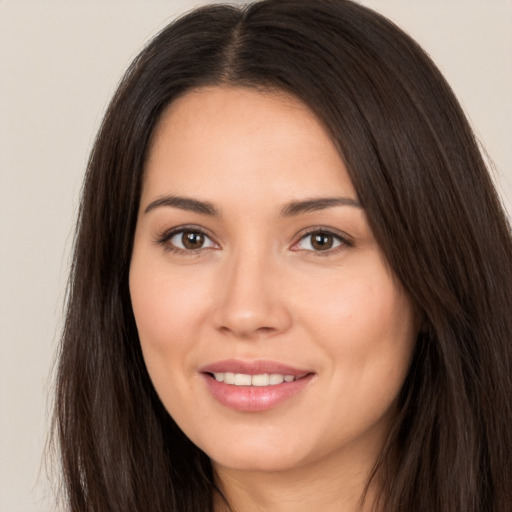 Joyful white young-adult female with long  brown hair and brown eyes