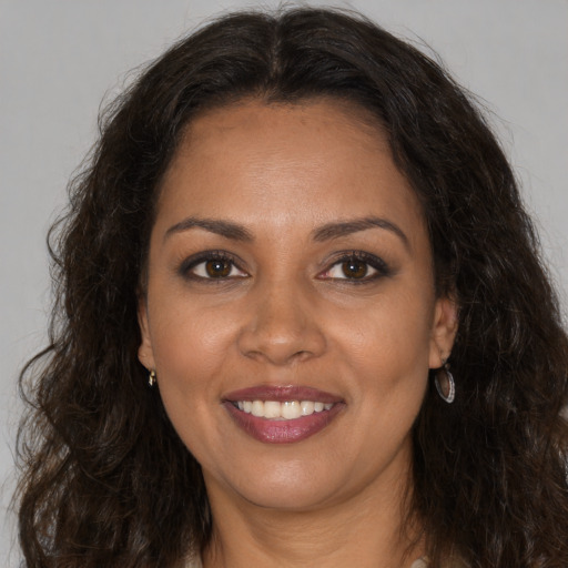 Joyful white adult female with long  brown hair and brown eyes