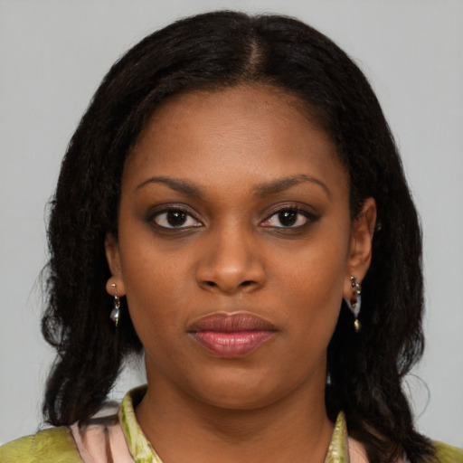 Neutral black young-adult female with medium  brown hair and brown eyes