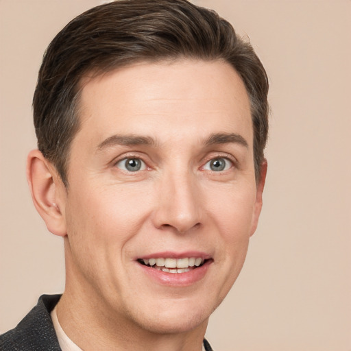 Joyful white adult male with short  brown hair and grey eyes