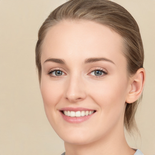 Joyful white young-adult female with long  brown hair and green eyes