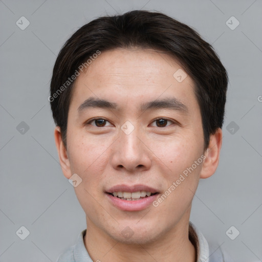 Joyful asian young-adult male with short  brown hair and brown eyes