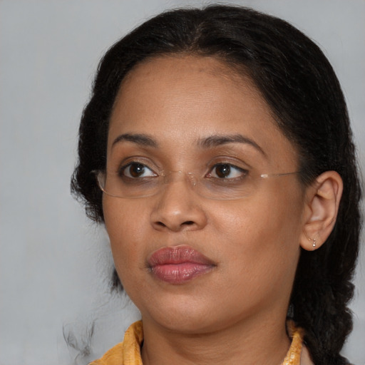 Joyful black young-adult female with medium  brown hair and brown eyes