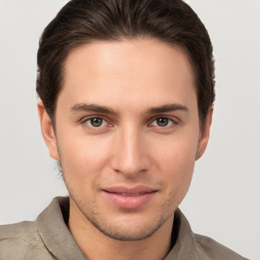 Joyful white young-adult male with short  brown hair and brown eyes