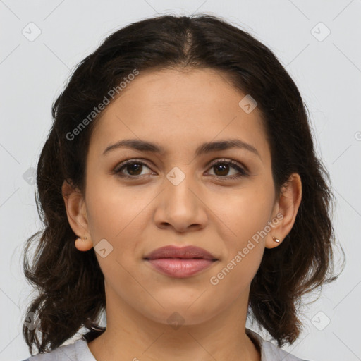 Joyful latino young-adult female with medium  brown hair and brown eyes