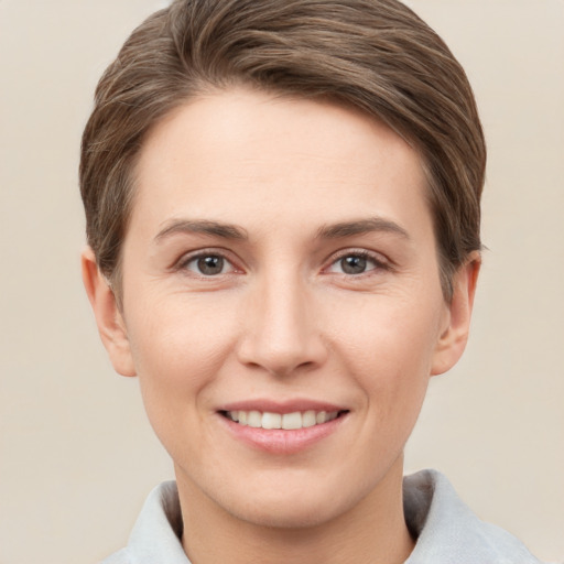 Joyful white young-adult female with short  brown hair and grey eyes