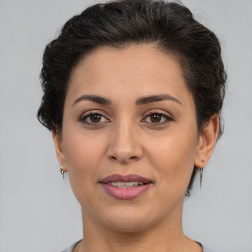 Joyful white adult female with short  brown hair and brown eyes