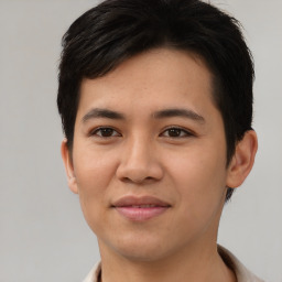 Joyful asian young-adult male with short  brown hair and brown eyes