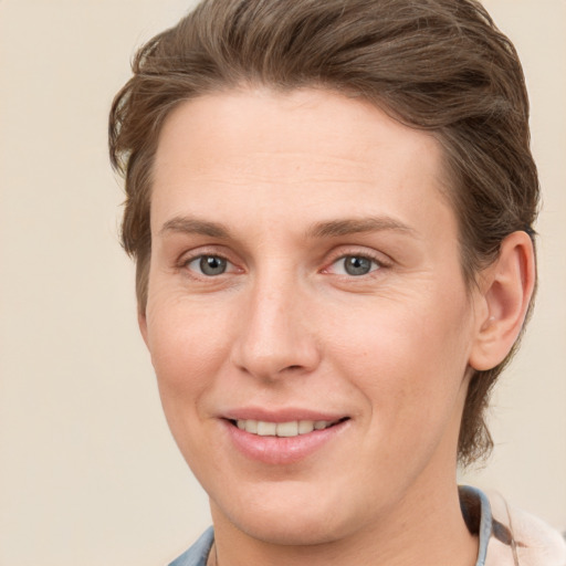 Joyful white young-adult female with short  brown hair and grey eyes