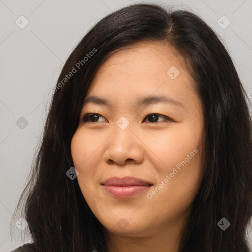 Joyful asian young-adult female with long  brown hair and brown eyes