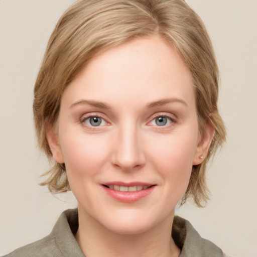 Joyful white young-adult female with medium  brown hair and blue eyes