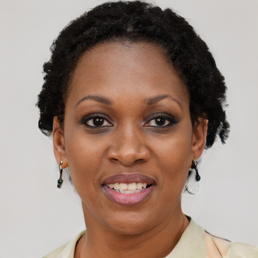 Joyful black adult female with short  brown hair and brown eyes