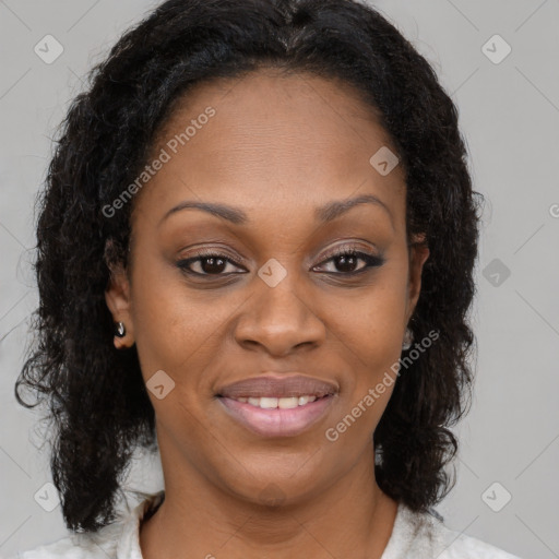 Joyful black young-adult female with long  brown hair and brown eyes