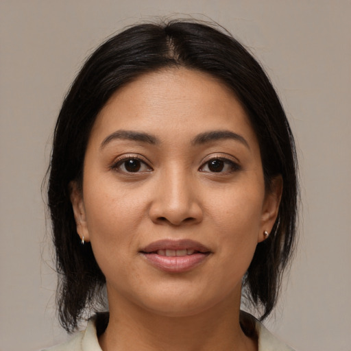 Joyful asian young-adult female with medium  brown hair and brown eyes