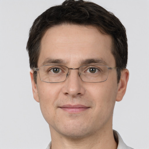 Joyful white adult male with short  brown hair and brown eyes