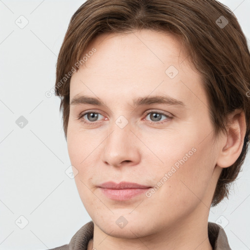 Joyful white young-adult female with short  brown hair and grey eyes