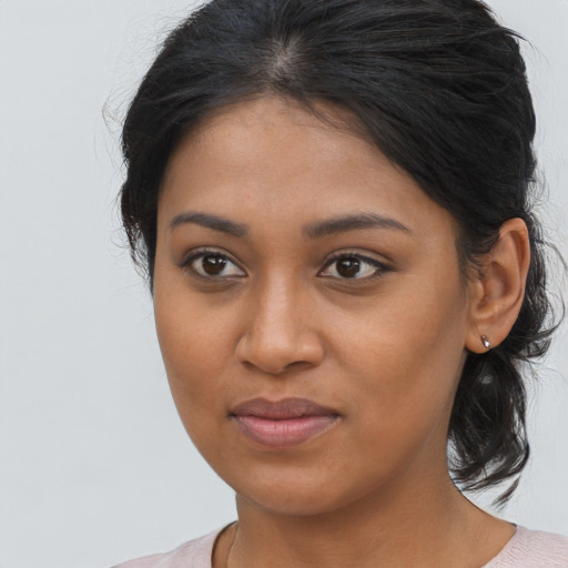 Joyful black young-adult female with medium  brown hair and brown eyes