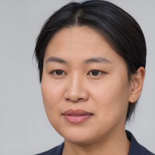 Joyful asian young-adult female with medium  brown hair and brown eyes