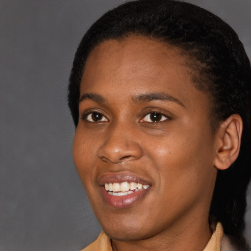 Joyful black young-adult female with short  brown hair and brown eyes