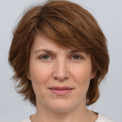 Joyful white adult female with medium  brown hair and brown eyes