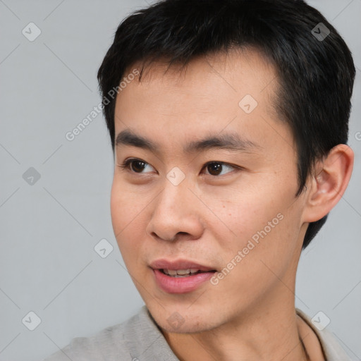 Joyful asian young-adult male with short  black hair and brown eyes