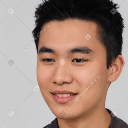 Joyful asian young-adult male with short  black hair and brown eyes