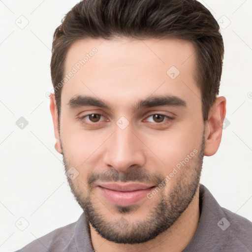 Joyful white young-adult male with short  brown hair and brown eyes