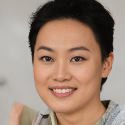 Joyful asian young-adult female with short  black hair and brown eyes