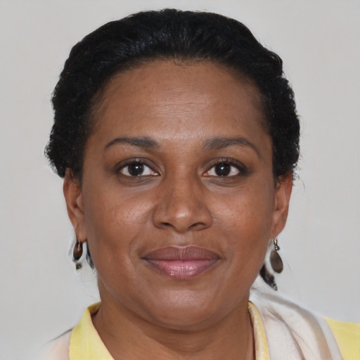 Joyful latino adult female with short  brown hair and brown eyes