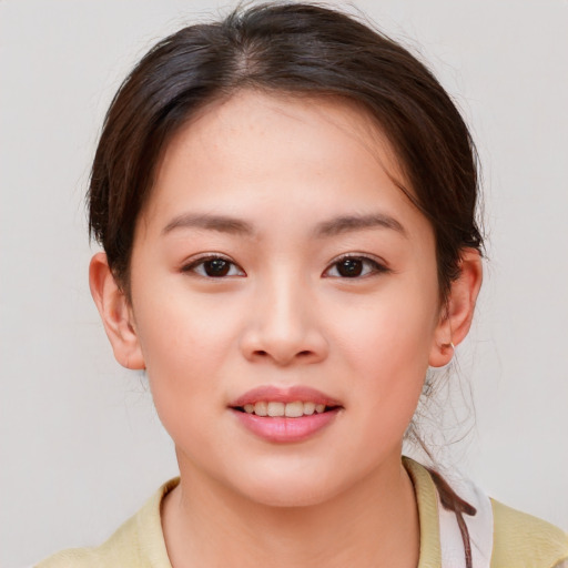 Joyful white child female with medium  brown hair and brown eyes