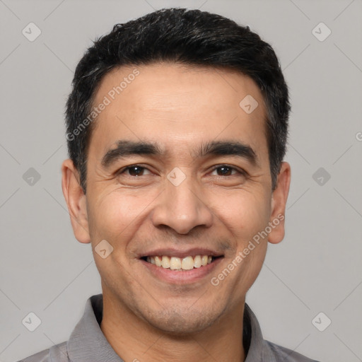 Joyful white young-adult male with short  black hair and brown eyes