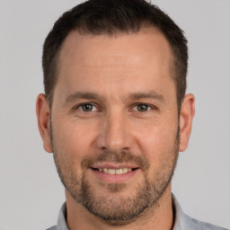 Joyful white adult male with short  brown hair and brown eyes