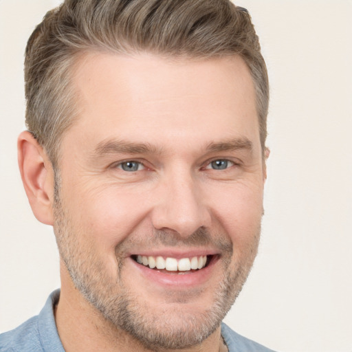 Joyful white adult male with short  brown hair and brown eyes