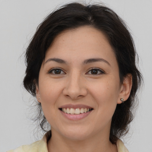 Joyful latino young-adult female with medium  brown hair and brown eyes