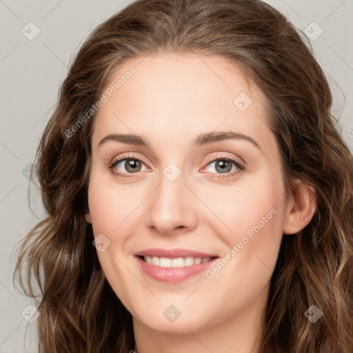 Joyful white young-adult female with long  brown hair and green eyes