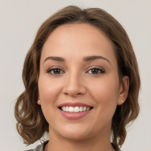 Joyful white young-adult female with medium  brown hair and grey eyes