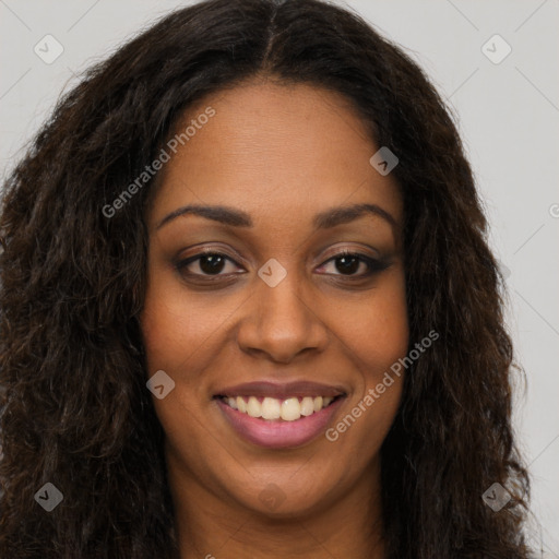 Joyful black young-adult female with long  brown hair and brown eyes