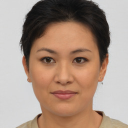 Joyful asian young-adult female with short  brown hair and brown eyes