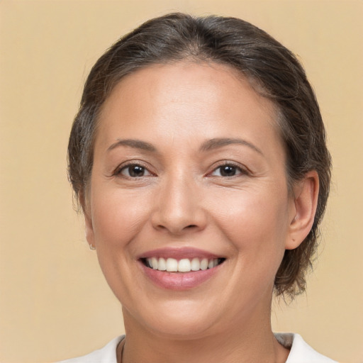 Joyful white adult female with medium  brown hair and brown eyes