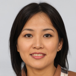 Joyful asian young-adult female with medium  brown hair and brown eyes